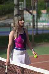 Beautiful Young woman playing tennis and possing outdoors, no edit image