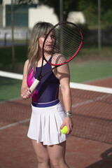 Beautiful Young woman playing tennis and possing outdoors, no edit image