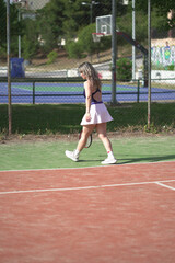 Obraz premium beautiful young woman playing tennis and possing outdoors, no edited image
