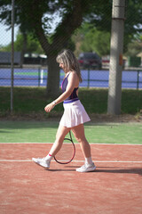 beautiful young woman playing tennis and possing outdoors, no edited image