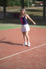 Fototapeta premium beautiful young woman playing tennis and possing outdoors, no edited image