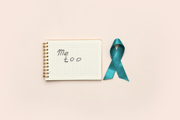 Teal ribbon and notebook with text ME TOO on beige background. Sexual Assault Awareness Month