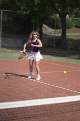 Obraz premium beautiful young woman playing tennis and possing outdoors, no edited image