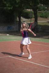 beautiful young woman playing tennis and possing outdoors, no edited image