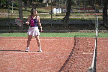 Obraz premium beautiful young woman playing tennis and possing outdoors, no edited image