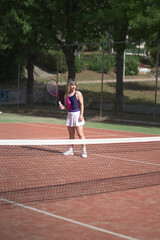 Obraz premium beautiful young woman playing tennis and possing outdoors, no edited image
