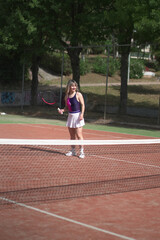 beautiful young woman playing tennis and possing outdoors, no edited image