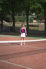 Fototapeta premium beautiful young woman playing tennis and possing outdoors, no edited image