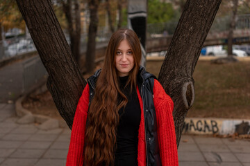 Young woman walking around the city and the parks in Autumn time. 