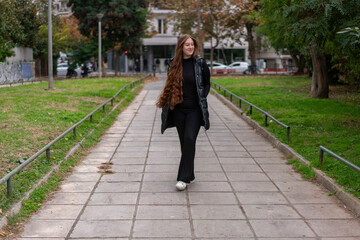 Young woman walking around the city and the parks in Autumn time.