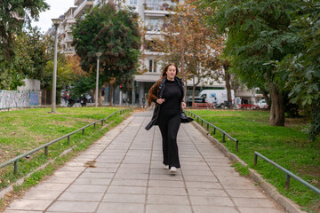 Young woman walking around the city and the parks in Autumn time.