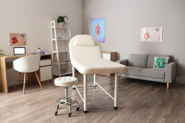 Interior of medical office with couch, sofa and doctor's workplace