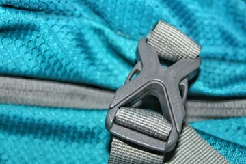 The buckle on a backpack is made of plastic.
