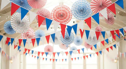 Obraz premium Festive red, white, and blue paper decorations hang from a high ceiling, creating a celebratory atmosphere.