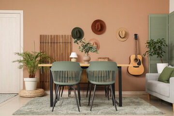 Interior of dining room with table, chairs and guitar