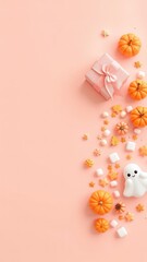 Fototapeta premium Festive seasonal design arrangement featuring pumpkins, a gift, sweets and a friendly ghost on a light background