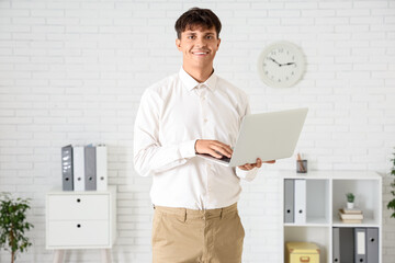 Fototapeta premium Handsome businessman working with laptop in office