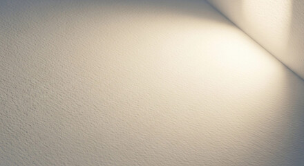 Light gradient on a textured wall, creating a soft, minimalist abstract composition with a corner detail.