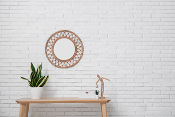 Modern living room with table, houseplant and mirror