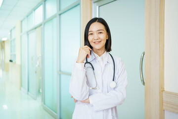 Portrait of Asian female doctor smiles with confidence to camera.