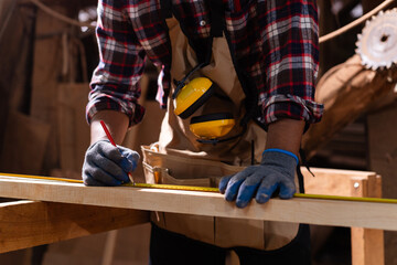 Professional African male carpenter is working professionally in sawmill - workshop.