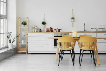 Dining table with candles in kitchen