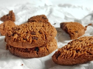 Chocolate Cookies on White Paper with Crumbs