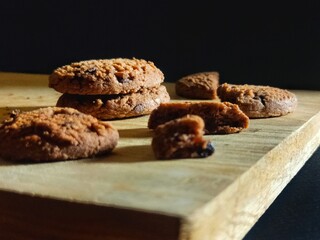 Chocolate Cookies on Wooden Surface with Shadows