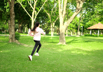 A young woman in sportswear is preparing to exercise in nature. Running for health and a good...