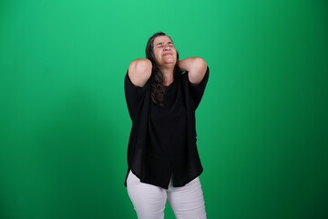 Fototapeta premium Unedited Portrait of Woman’s Face Expressing Various Emotions – Green Studio Background