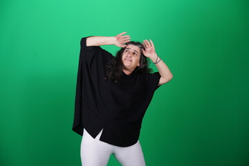 Fototapeta premium Unedited Portrait of Woman’s Face Expressing Various Emotions – Green Studio Background