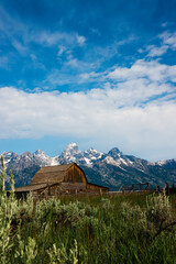 mountain barn landscape with blue sky