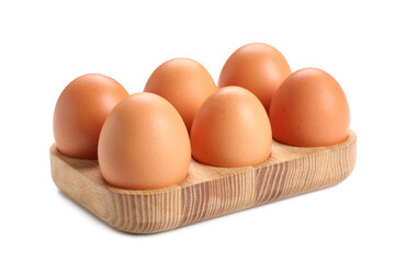 Wooden holder with brown chicken eggs on white background
