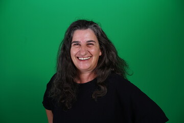 Fototapeta premium Unedited Portrait of Woman’s Face Expressing Various Emotions – Green Studio Background