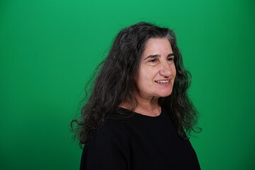 Obraz premium Unedited Portrait of Woman’s Face Expressing Various Emotions – Green Studio Background