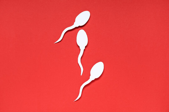 Sperm cells on red background - Powered by Adobe