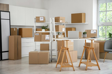 Interior of warehouse with workplace, shelf units and parcel boxes