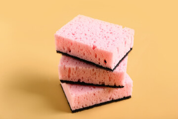 Stack of sponges for cleaning on beige background