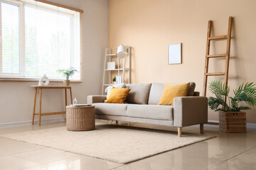 New sofa and wicker table in modern interior of living room