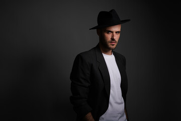 Young man with a variety of emotions, wearing a white t-shirt standing against a green background. Studio shot with copy space.