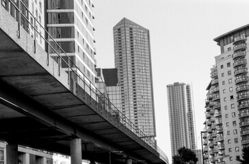 Elevated concrete road passing through modern buildings in canary wharf, london