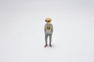 Stylized Figurine Featuring a Playful Emojis Head in Casual Wear