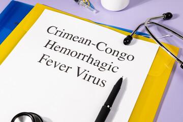 A Paper with “Crimean-Congo Hemorrhagic Fever Virus” Title in Clipboard Set on the Desk with...