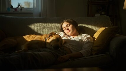 Peaceful young woman and her loyal dog nap together on a cozy living room sofa - Powered by Adobe