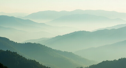 Misty mountain range, soft light, layered peaks, tranquil scene.