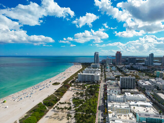 Fototapeta premium Beach in Miami with sunbed on a sandy beach with ocean waves. Miami Beach paradise with stunning views. South Beach Miami lifeguard post. Peaceful seaside retreat in Miami. Coastal relaxation.