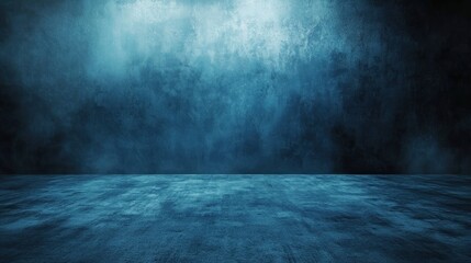 A dark blue, textured wall with a concrete floor in a room with a single light source casting a shadow on the floor.