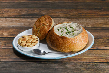 A bowl of New England style Clam Chowder with a side of Oyster Crackers. 