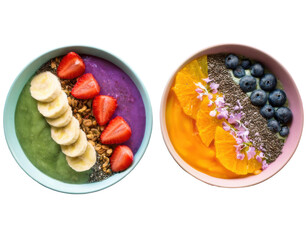 Top-down view of two vibrant smoothie bowls arranged in rainbow layers with colorful toppings