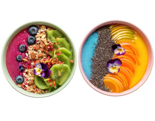 Top-down view of two vibrant smoothie bowls arranged in rainbow layers with colorful toppings